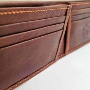 Brown leather wallet with Pila Luxuria script logo up close