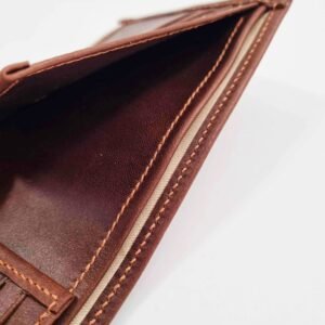 Brown leather wallet with cloth lined pocket and hand stitching.