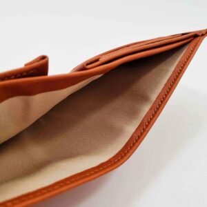 Brown leather wallet open showing cloth cash pocket