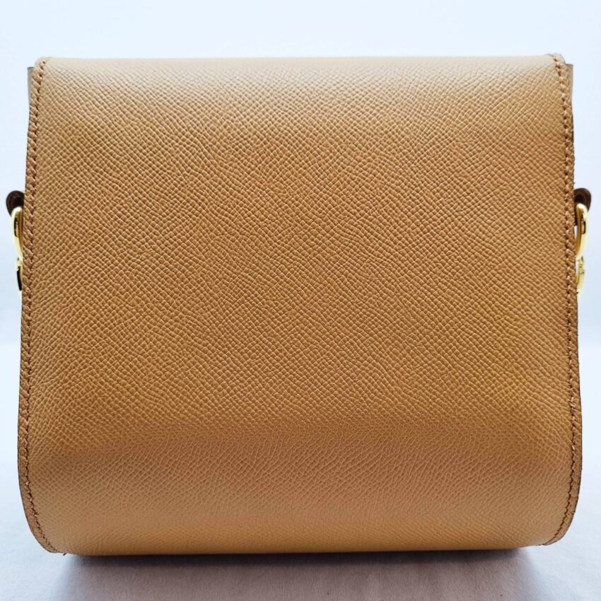 A biscuit colored epsom leather purse made by Pila Luxuria in Alberta, Canada displayed from the rear.