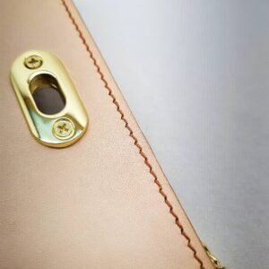 A biscuit colored epsom leather purse made by Pila Luxuria in Alberta, Canada showing detailed stitching.
