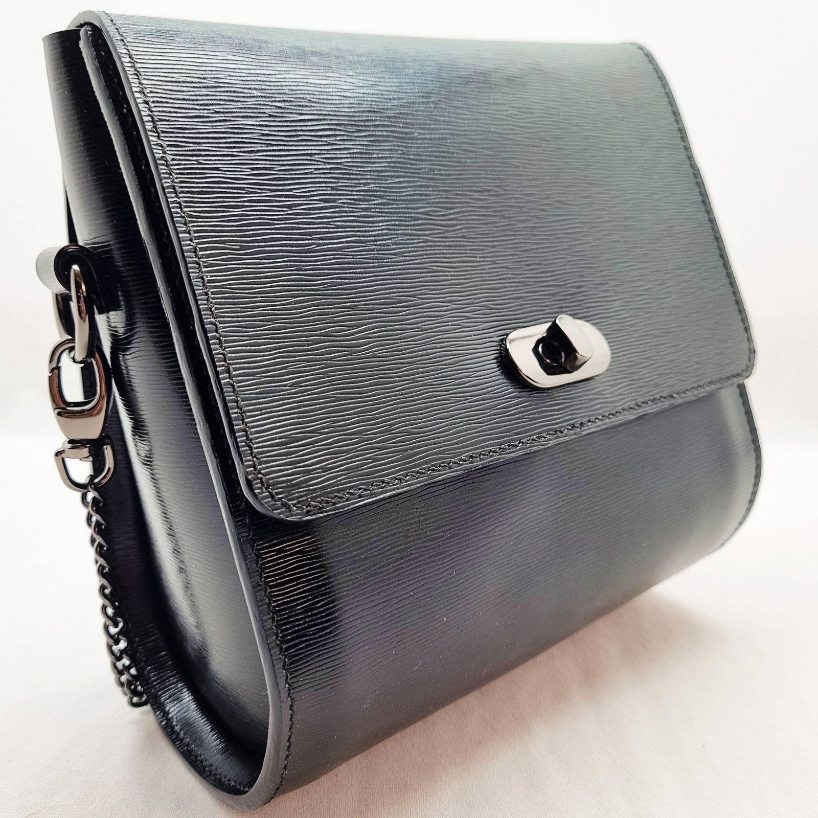 A black epi leather purse made by Pila Luxuria in Alberta, Canada displayed from an angle.