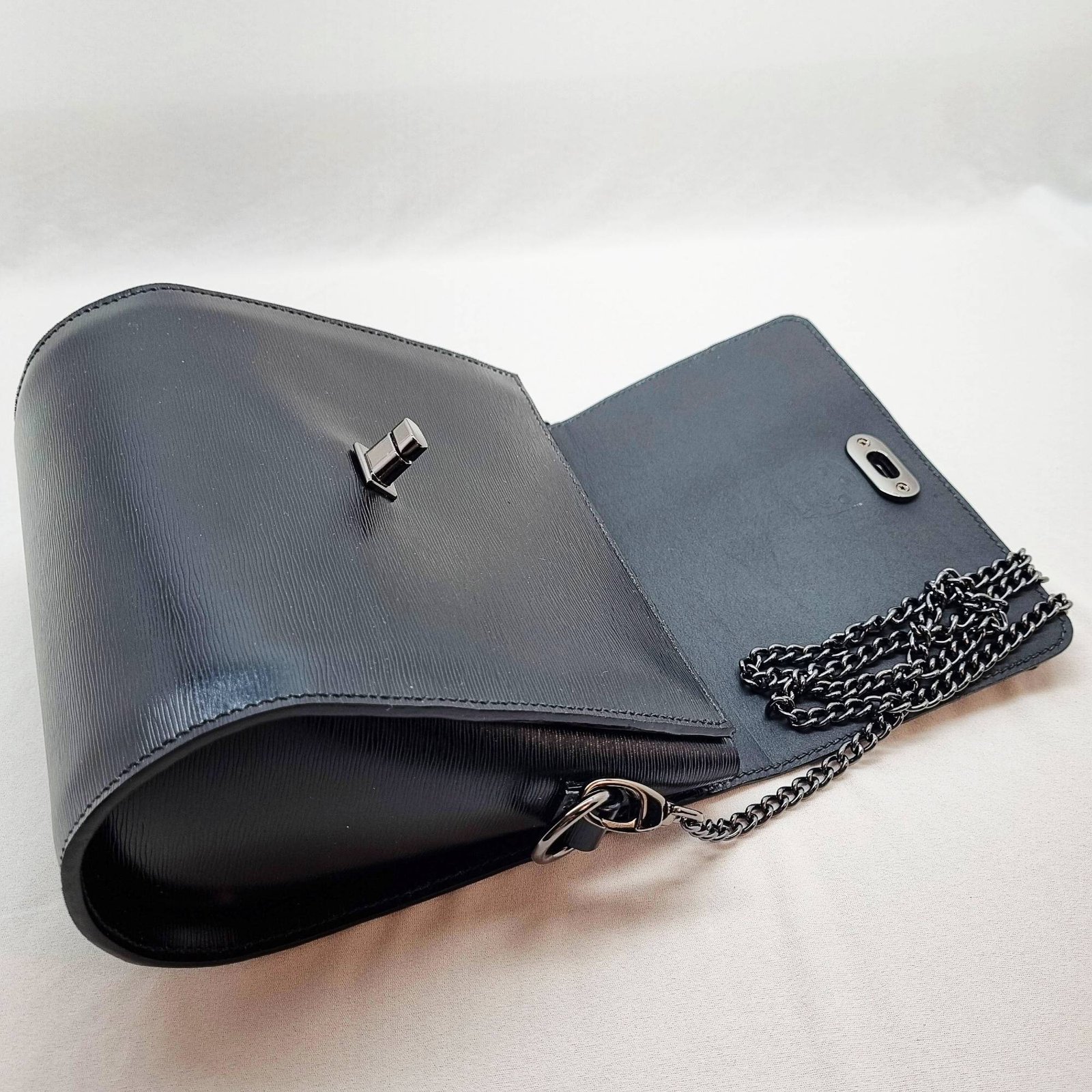 A black epi leather purse made by Pila Luxuria in Alberta, Canada laid open.