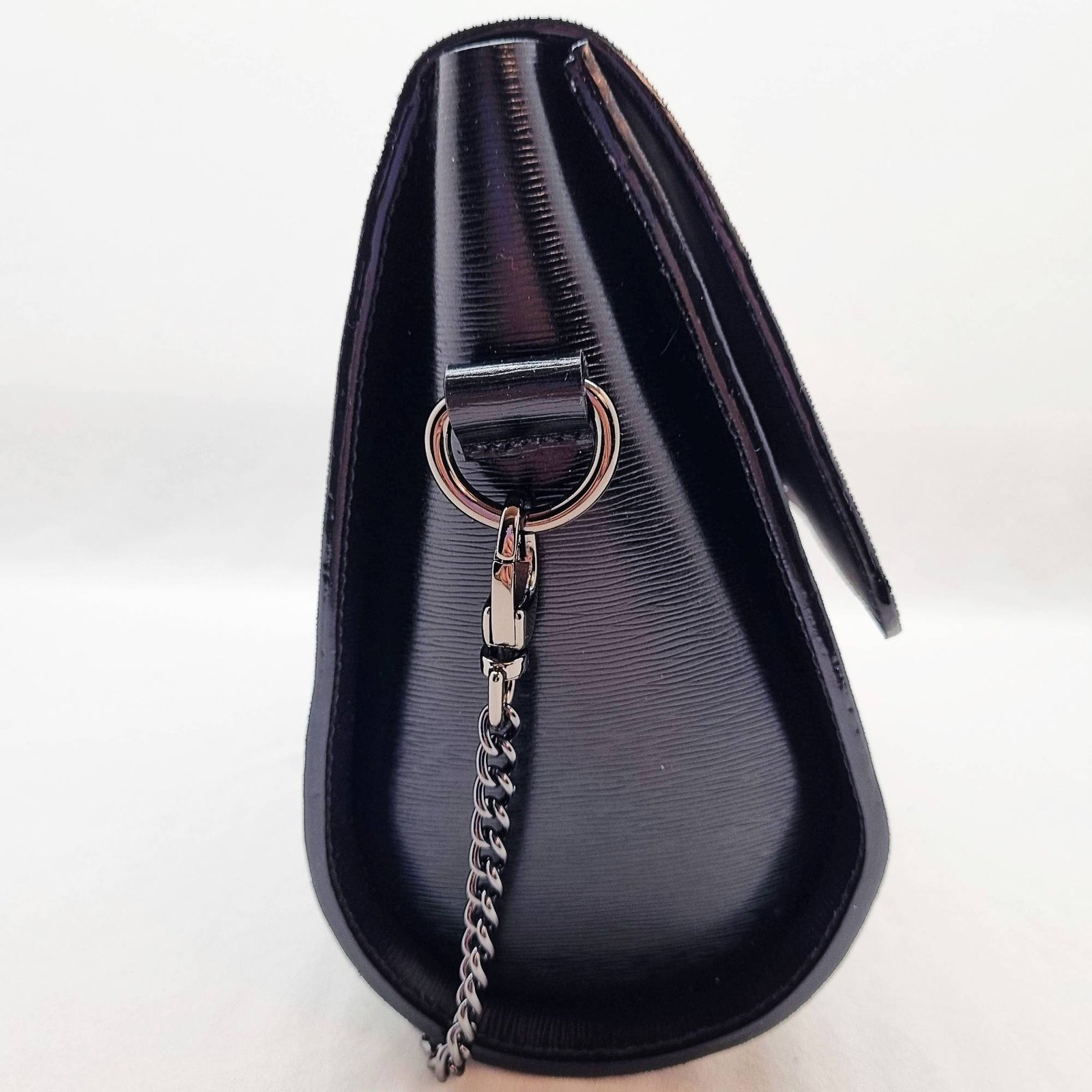 A black epi leather purse made by Pila Luxuria in Alberta, Canada displayed from the side.