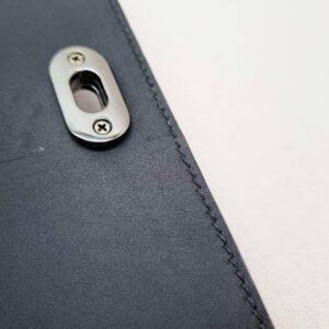 A black epi leather purse made by Pila Luxuria in Alberta, Canada showing detailed stitching.