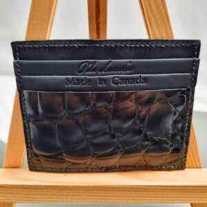 Black mirror finish crocodile leather card holder made by Pila Luxuria in Canada shown from the front.