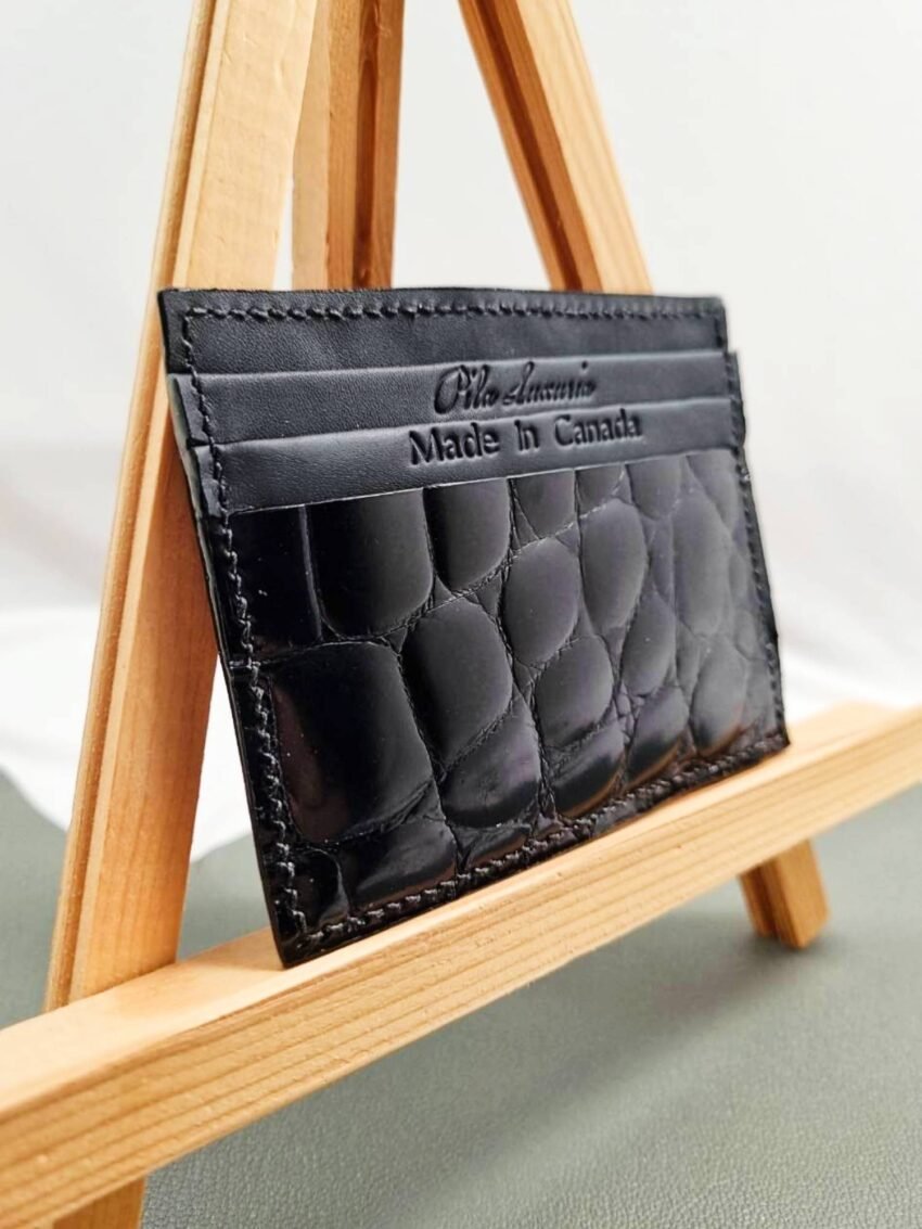 Black mirror finish crocodile leather card holder made by Pila Luxuria in Canada shown from an angle.