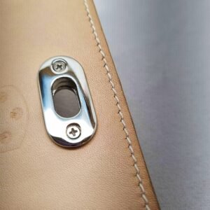 A craie colored epsom leather purse made by Pila Luxuria in Alberta, Canada showing detailed stitching.