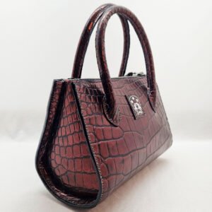 pila-luxuria-dark-cherry-alligator-leather-tulip-handbag-angle1.jpg An exotic red alligator leather handbag made by Pila Luxuria in Alberta, Canada shown from the front angle.