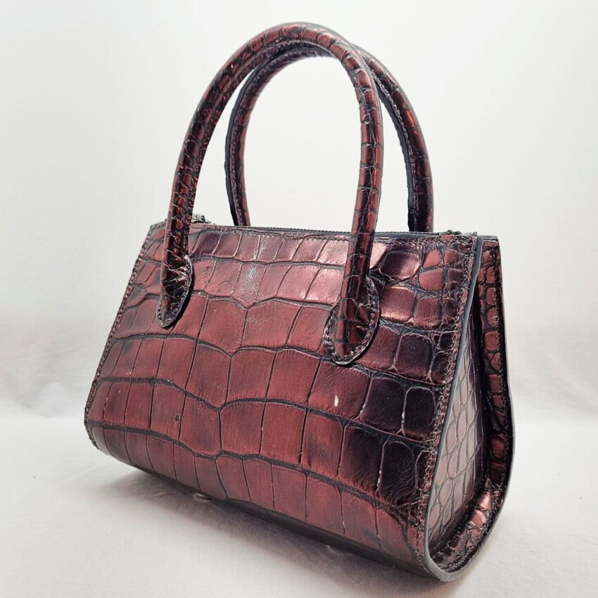 An exotic red alligator leather handbag made by Pila Luxuria in Alberta, Canada shown from the rear angle.