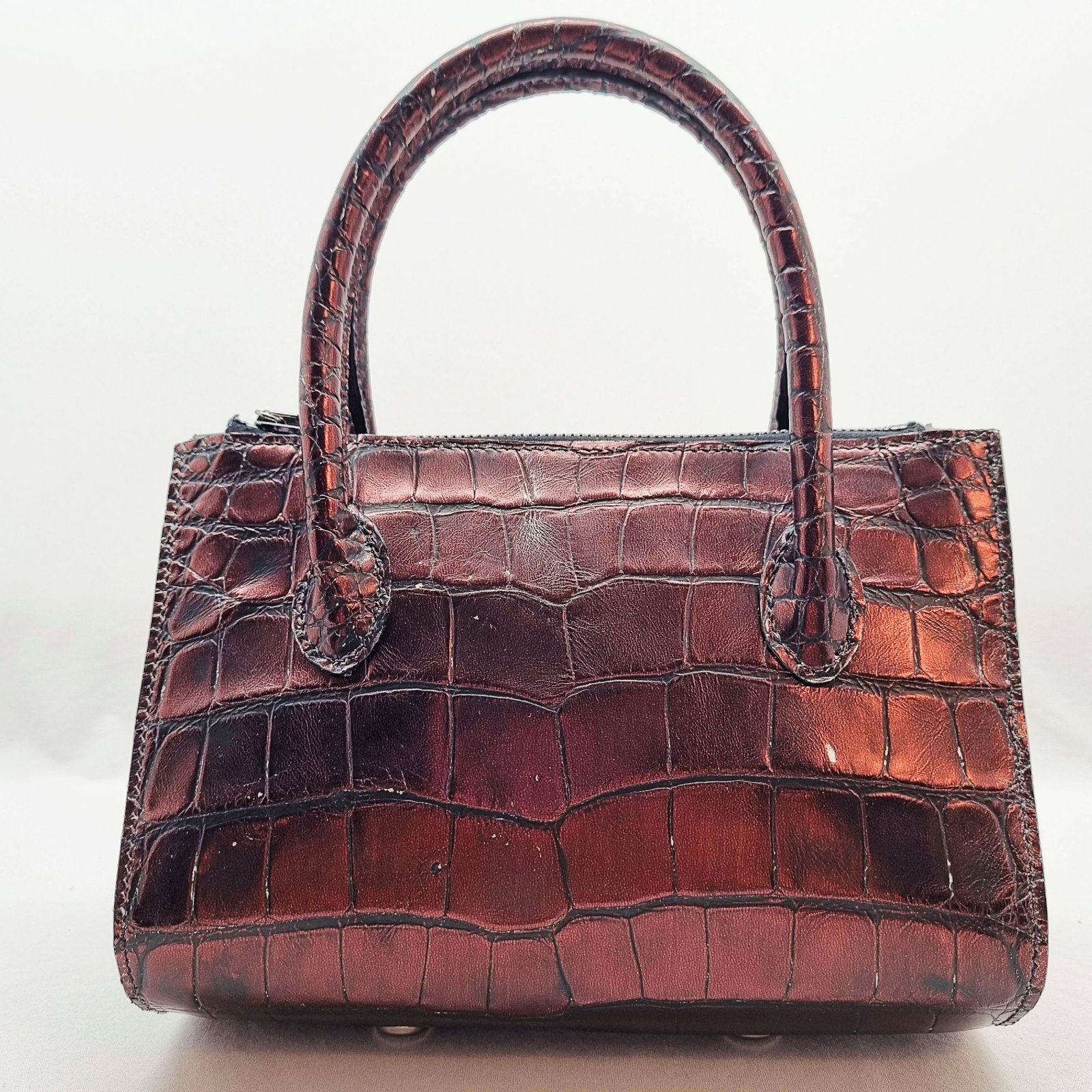 An exotic red alligator leather handbag made by Pila Luxuria in Alberta, Canada shown from the back.