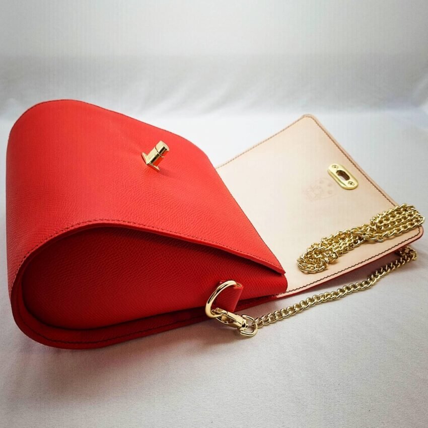 A rouge colored epsom leather purse made by Pila Luxuria in Alberta, Canada laid open.