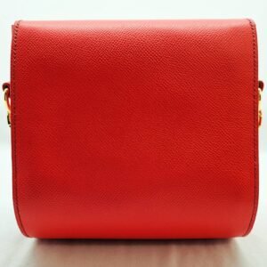 A rouge colored epsom leather purse made by Pila Luxuria in Alberta, Canada displayed from the rear.