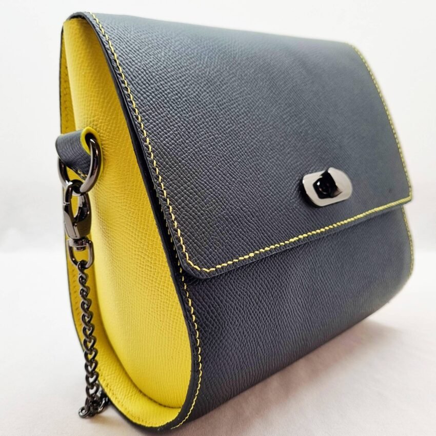 A black and yellow epsom leather purse made by Pila Luxuria in Alberta, Canada displayed from an angle.