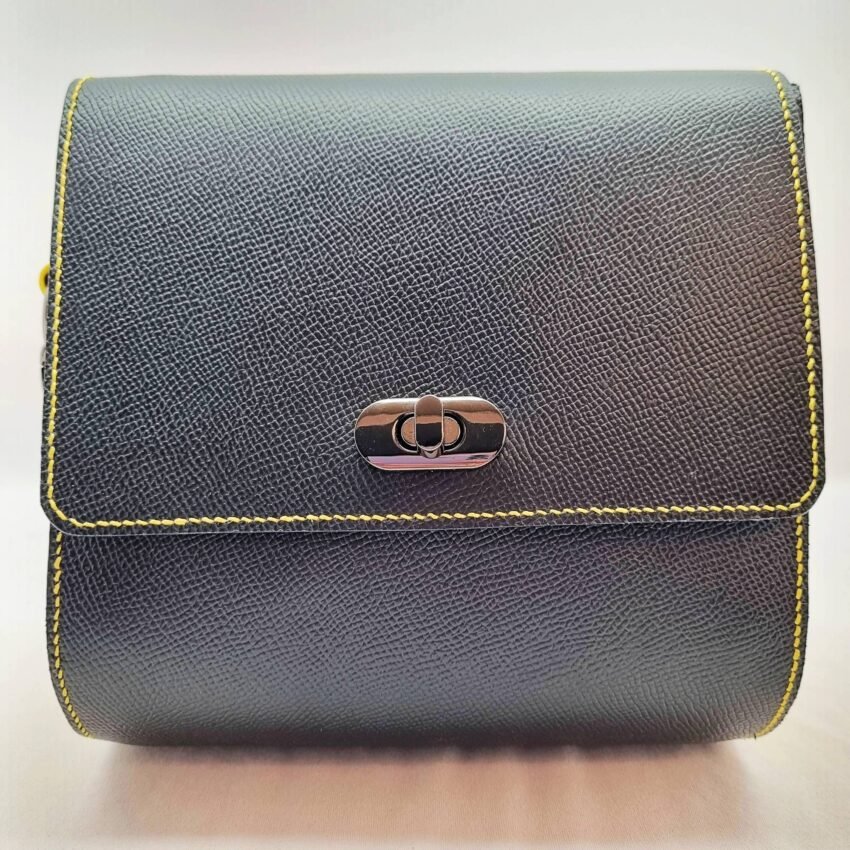 A black and yellow epsom leather purse made by Pila Luxuria in Alberta, Canada displayed from the front.