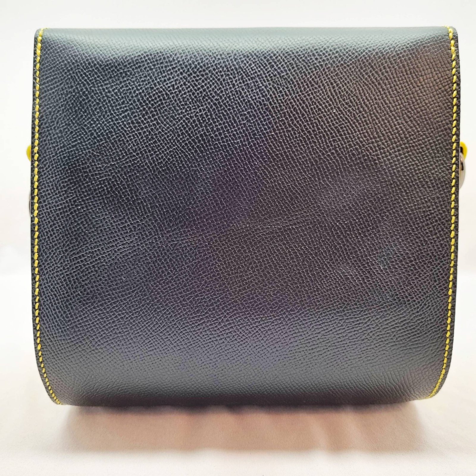 A black and yellow epsom leather purse made by Pila Luxuria in Alberta, Canada displayed from the back.