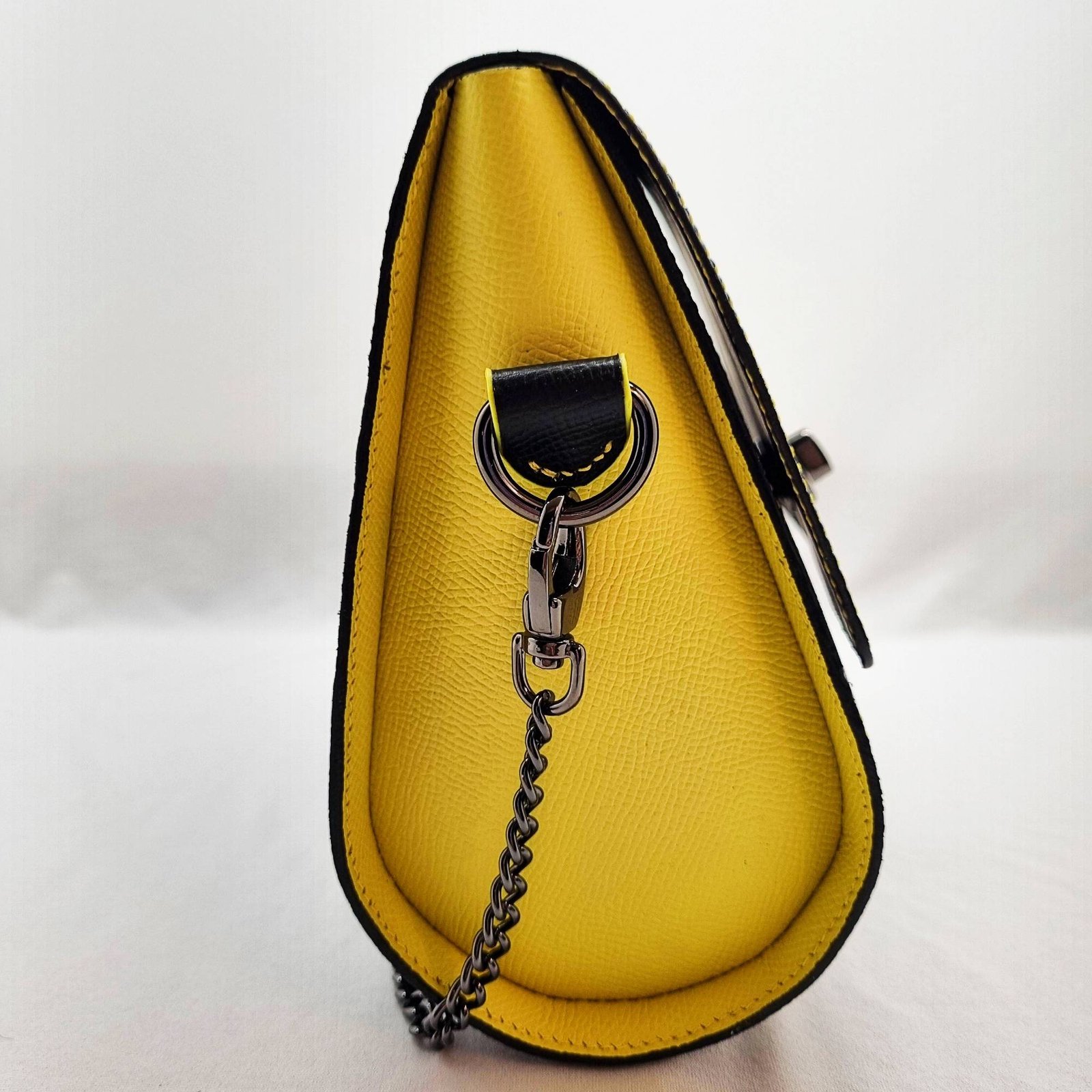 A black and yellow epsom leather purse made by Pila Luxuria in Alberta, Canada displayed from the side.