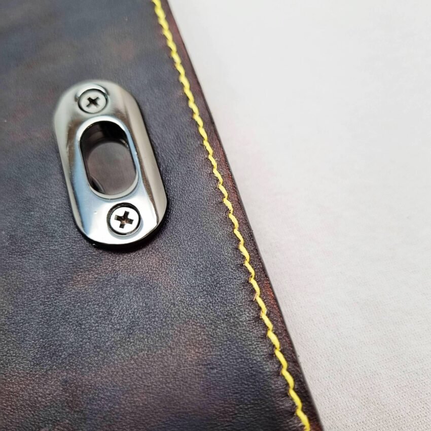 A black and yellow epsom leather purse made by Pila Luxuria in Alberta, Canada showing detailed stitching.