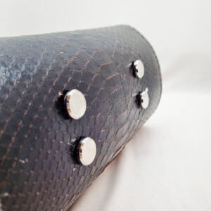 An exotic black python leather handbag made by Pila Luxuria in Alberta, Canada shown from the bottom.