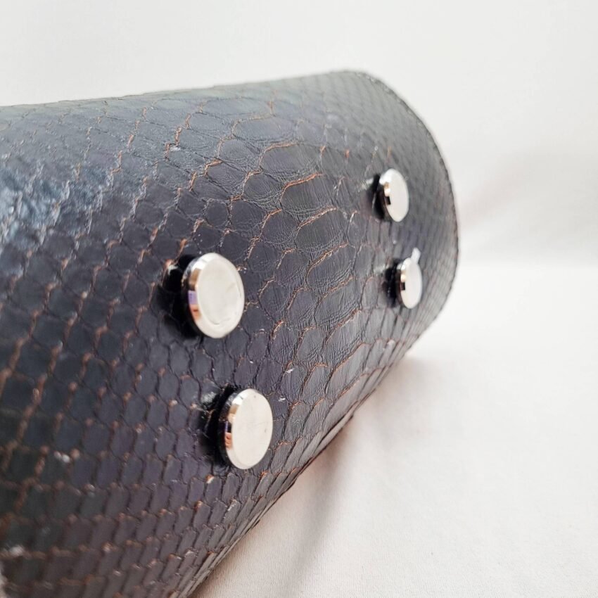 An exotic black python leather handbag made by Pila Luxuria in Alberta, Canada shown from the bottom.
