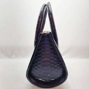 An exotic black python leather handbag made by Pila Luxuria in Alberta, Canada shown from the side.