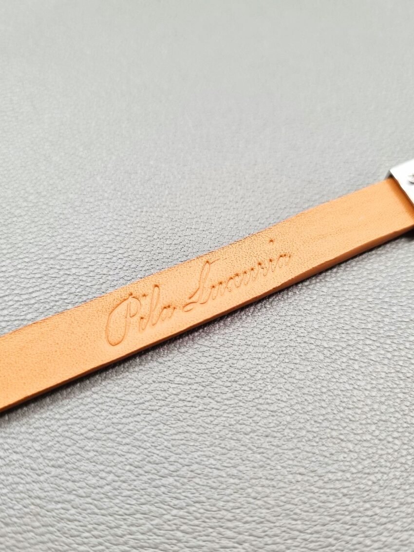 Embossed logo of a luxury biscuit epsom leather bracelet with a magnetic clasp, made by Pila Luxuria in Canada.