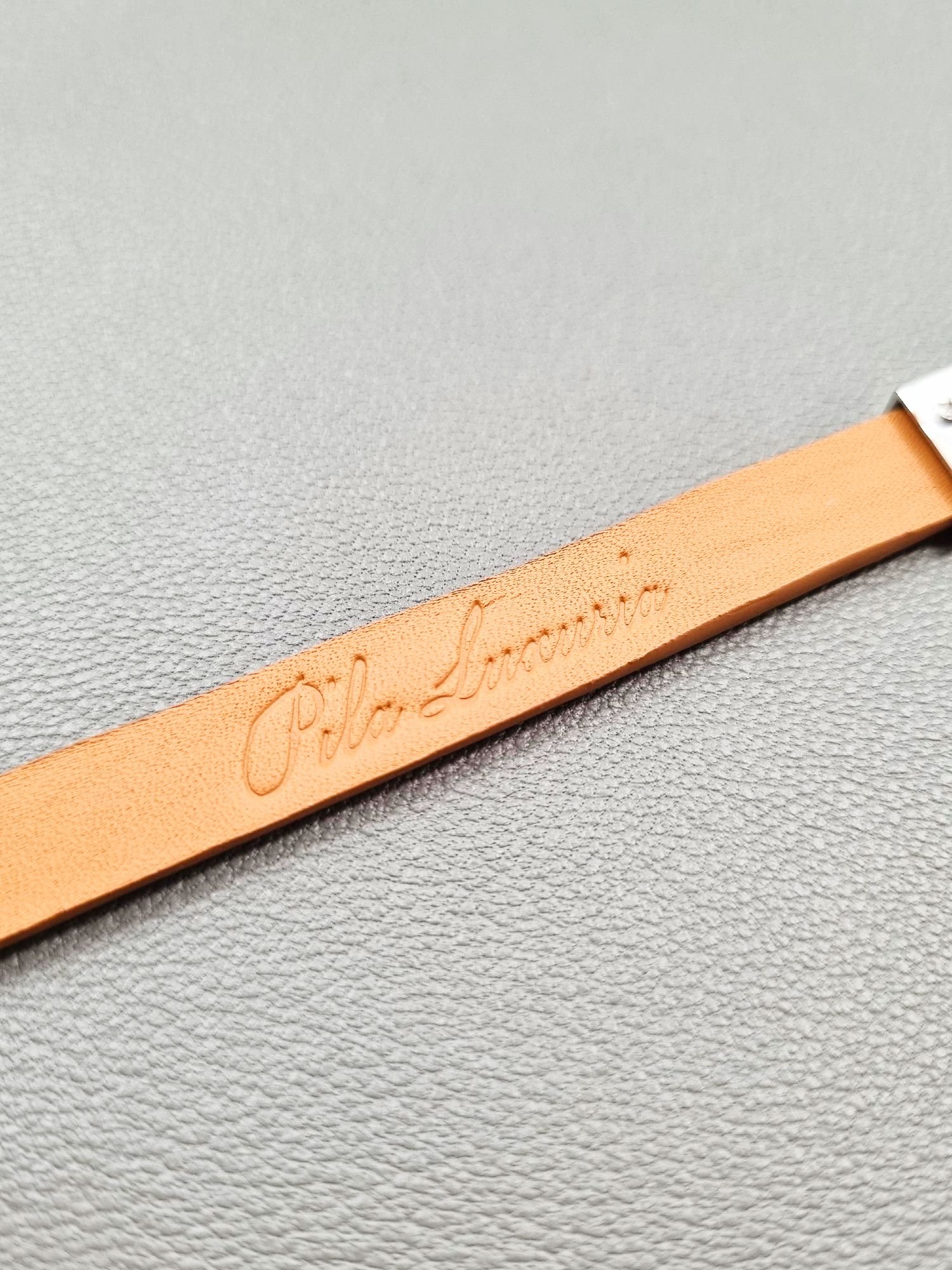 Embossed logo of a luxury biscuit epsom leather bracelet with a magnetic clasp, made by Pila Luxuria in Canada.