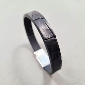 Angled view of a luxury black crocodile leather bracelet with a magnetic clasp, made by Pila Luxuria in Canada.