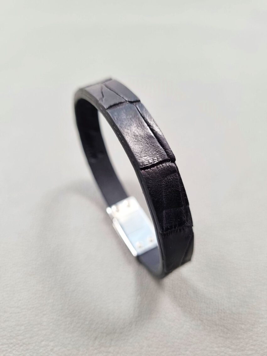 Angled view of a luxury black crocodile leather bracelet with a magnetic clasp, made by Pila Luxuria in Canada.