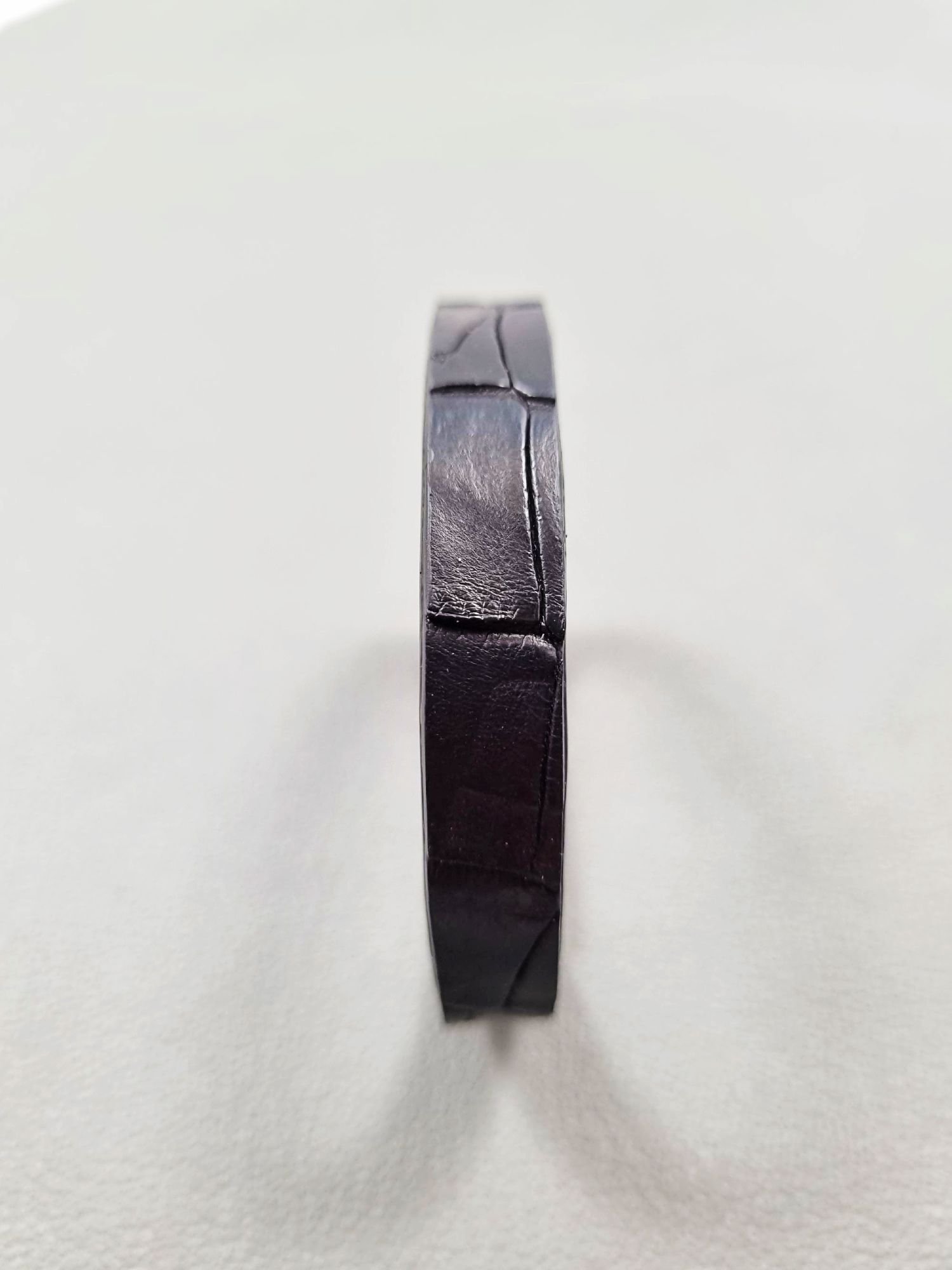 Forward view of a luxury black crocodile leather bracelet with a magnetic clasp, made by Pila Luxuria in Canada.