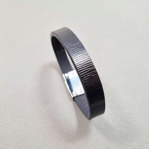 Angled view of a luxury black epi leather bracelet with a magnetic clasp, made by Pila Luxuria in Canada.