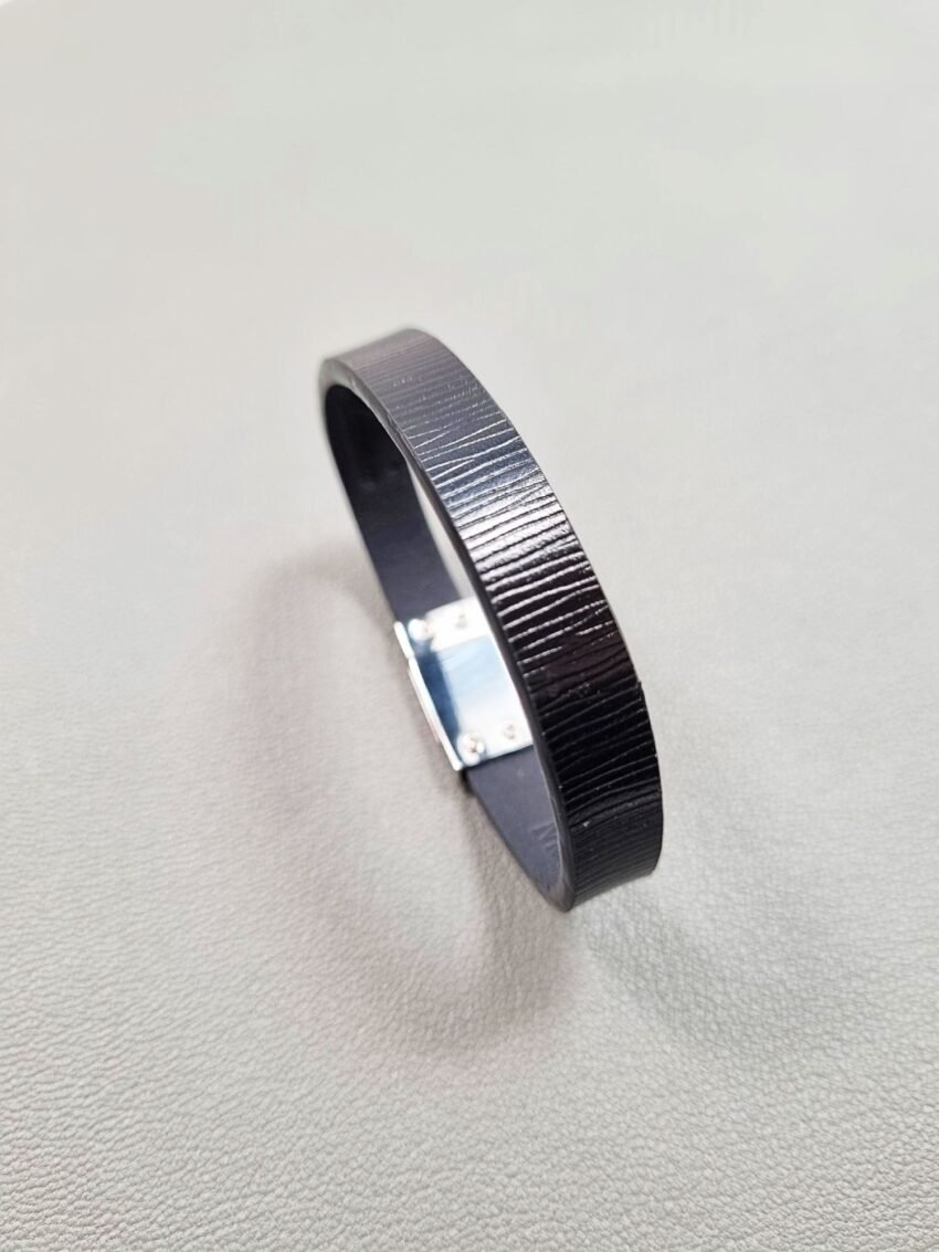 Angled view of a luxury black epi leather bracelet with a magnetic clasp, made by Pila Luxuria in Canada.