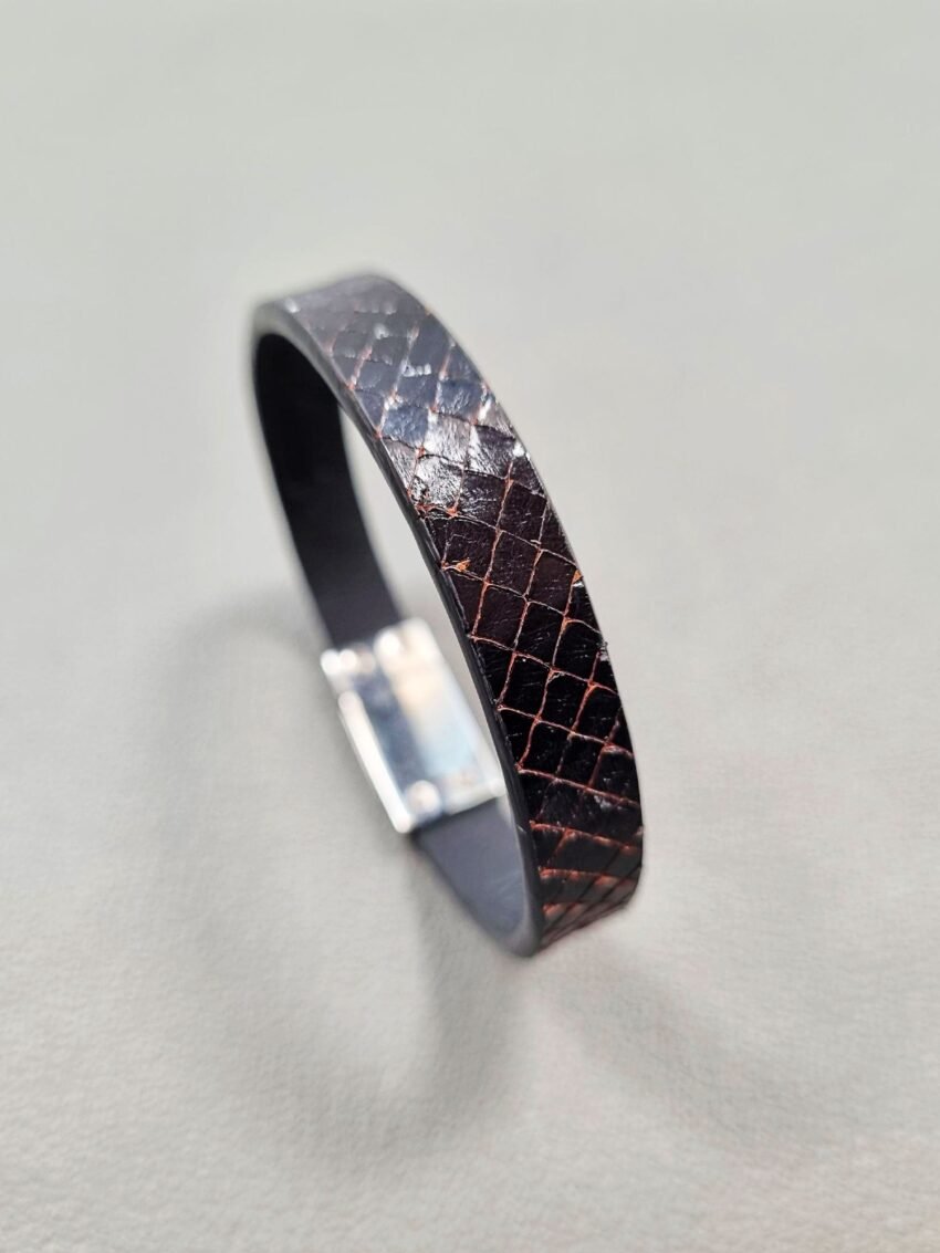 Angled view of a luxury tarnished python leather bracelet with a magnetic clasp, made by Pila Luxuria in Canada.