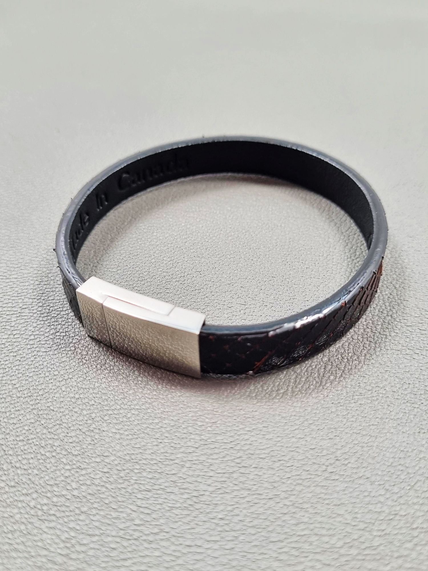 Top view of a luxury tarnished python leather bracelet with a magnetic clasp, made by Pila Luxuria in Canada.