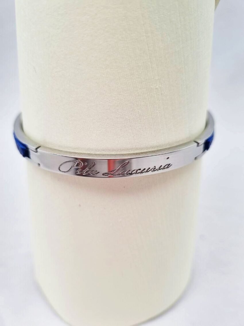 Logo of a luxury blue epsom clasp bracelet, made by Pila Luxuria in Canada.