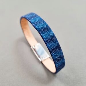 Angled view of a luxury blue stingray bracelet with a magnetic clasp, made by Pila Luxuria in Canada.