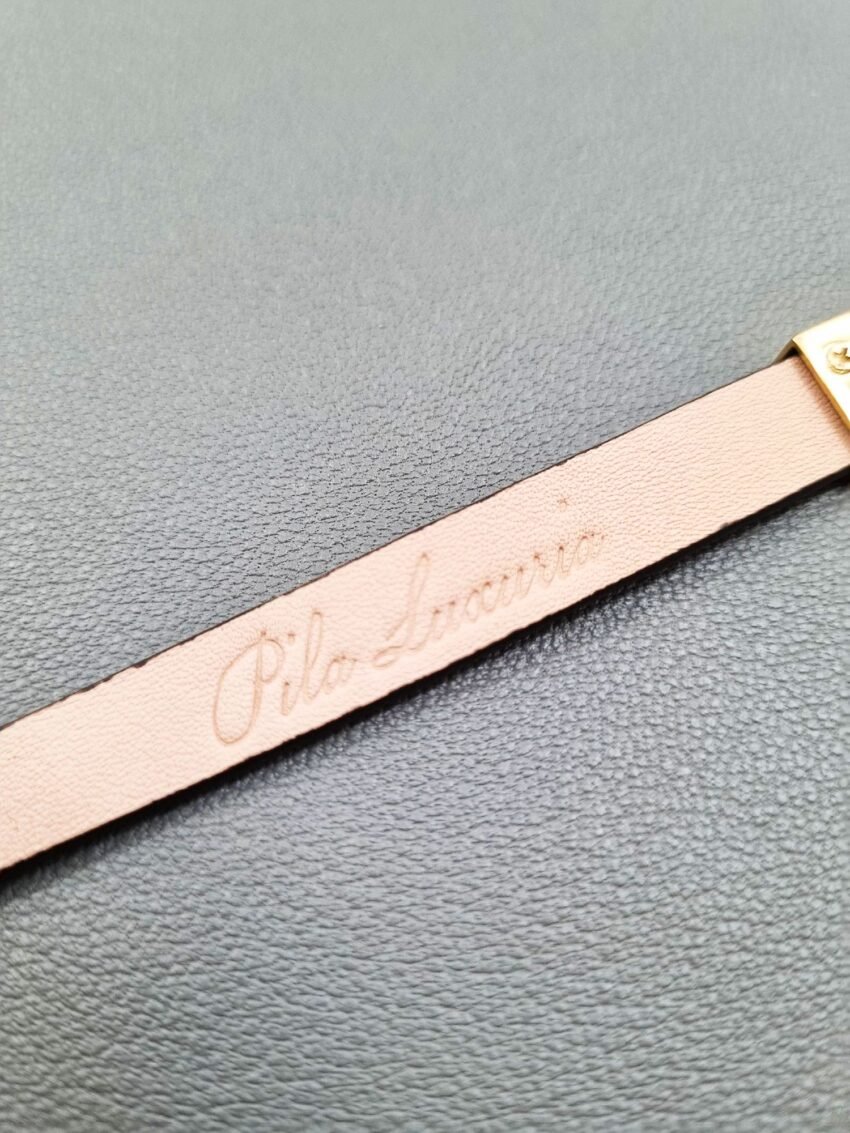 Brand logo of a luxury brown ostrich leather bracelet with a magnetic clasp, made by Pila Luxuria in Canada.