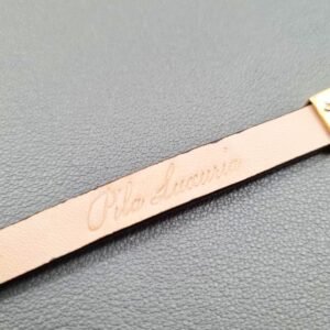 Embossed logo of a luxury brown calfskin leather bracelet with a magnetic clasp, made by Pila Luxuria in Canada.