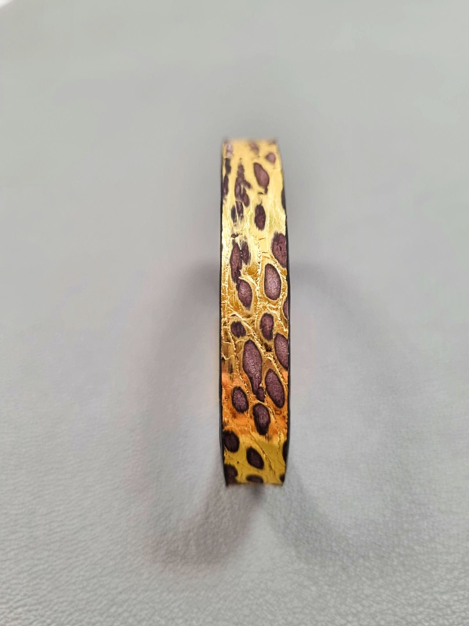 Forward view of a luxury brushed gold crocodile leather bracelet with a magnetic clasp, made by Pila Luxuria in Canada.