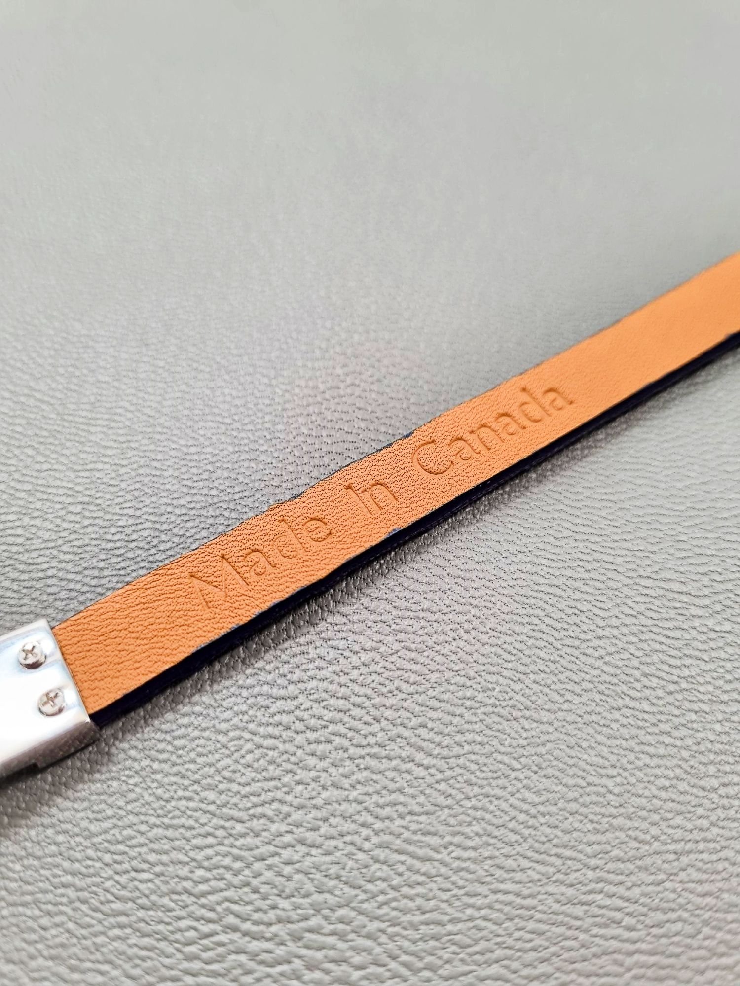 Embossed Made in Canada of a luxury cobalt crocodile leather bracelet with a magnetic clasp, made by Pila Luxuria in Canada.