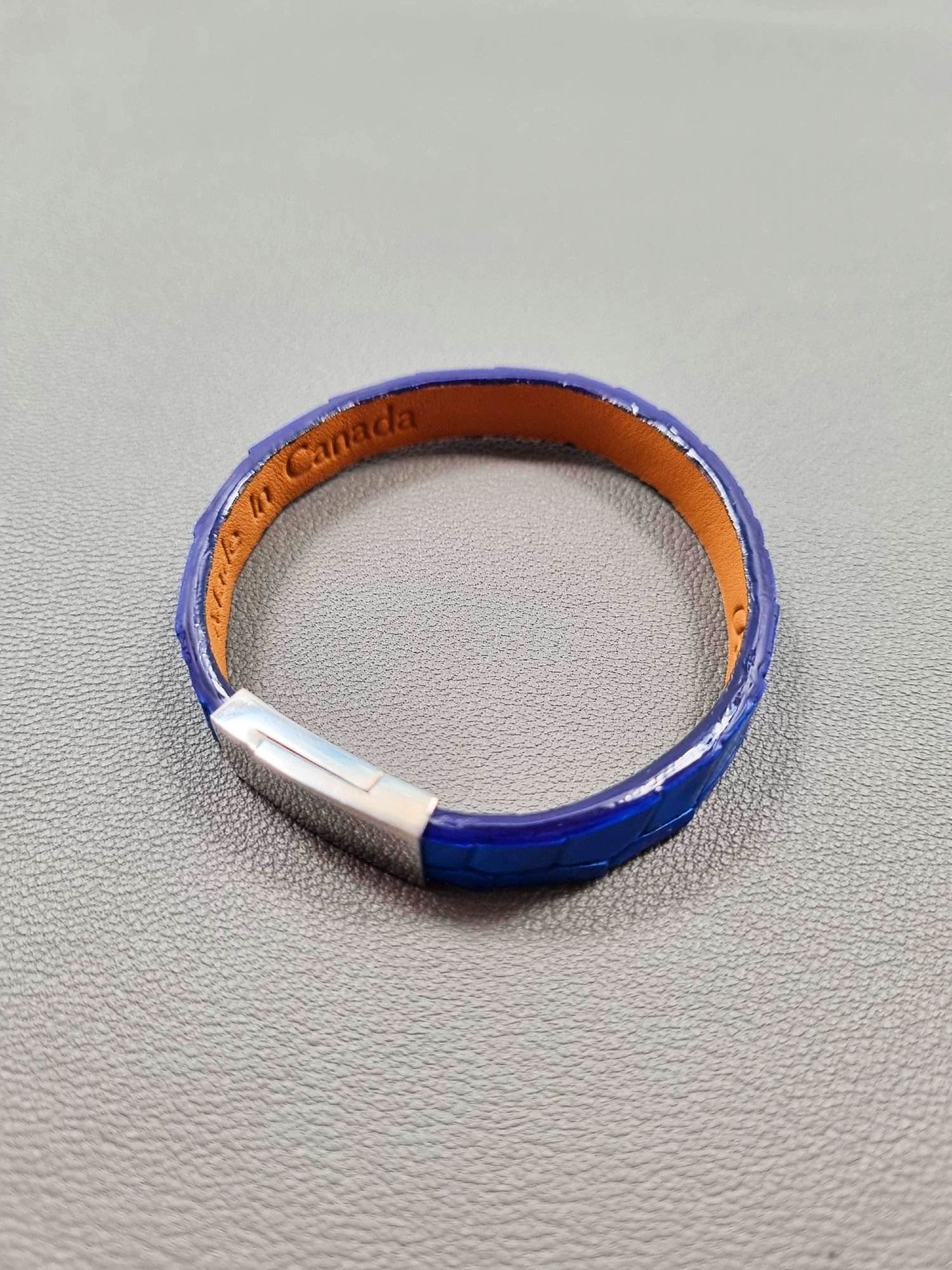 Top view of a luxury cobalt crocodile leather bracelet with a magnetic clasp, made by Pila Luxuria in Canada.