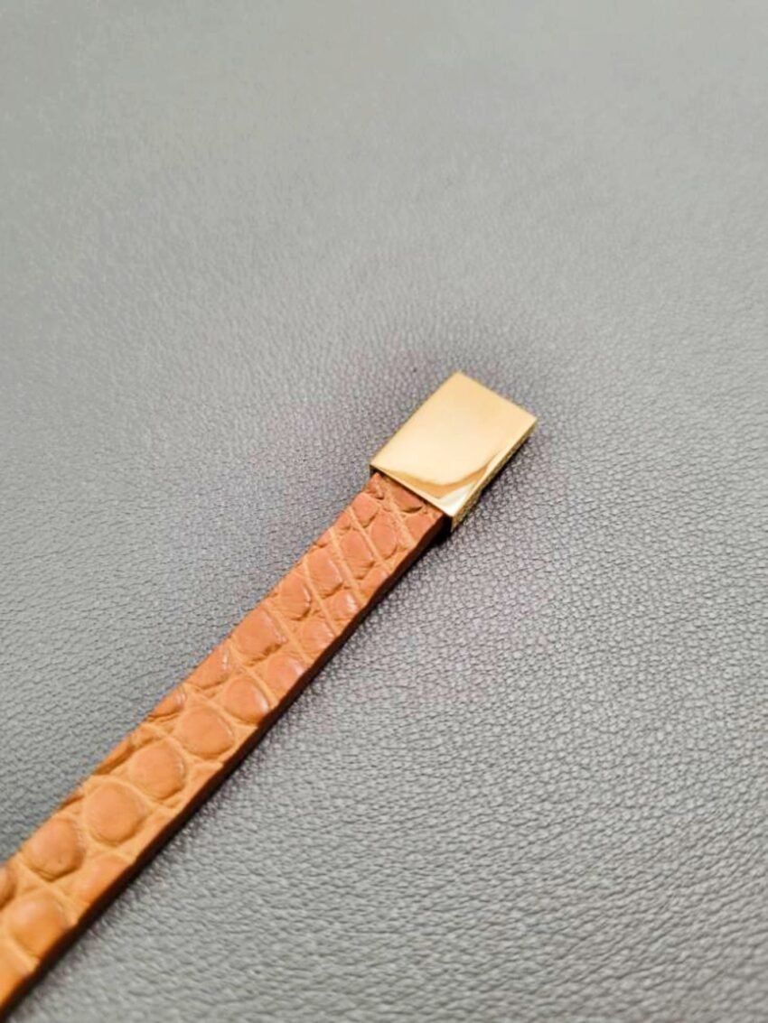 Cognac crocodile leather bracelet with a gold magnetic clasp, made by Pila Luxuria in Canada.