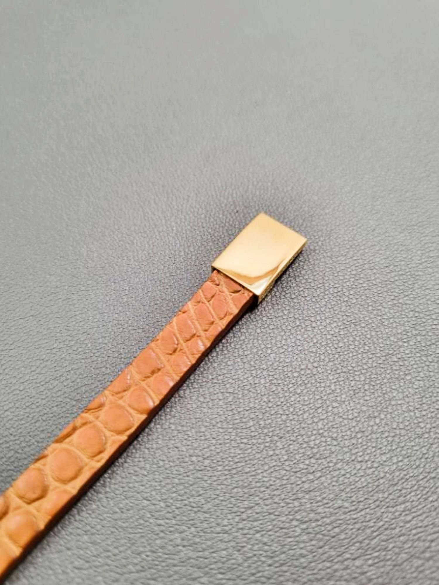 Cognac crocodile leather bracelet with a gold magnetic clasp, made by Pila Luxuria in Canada.