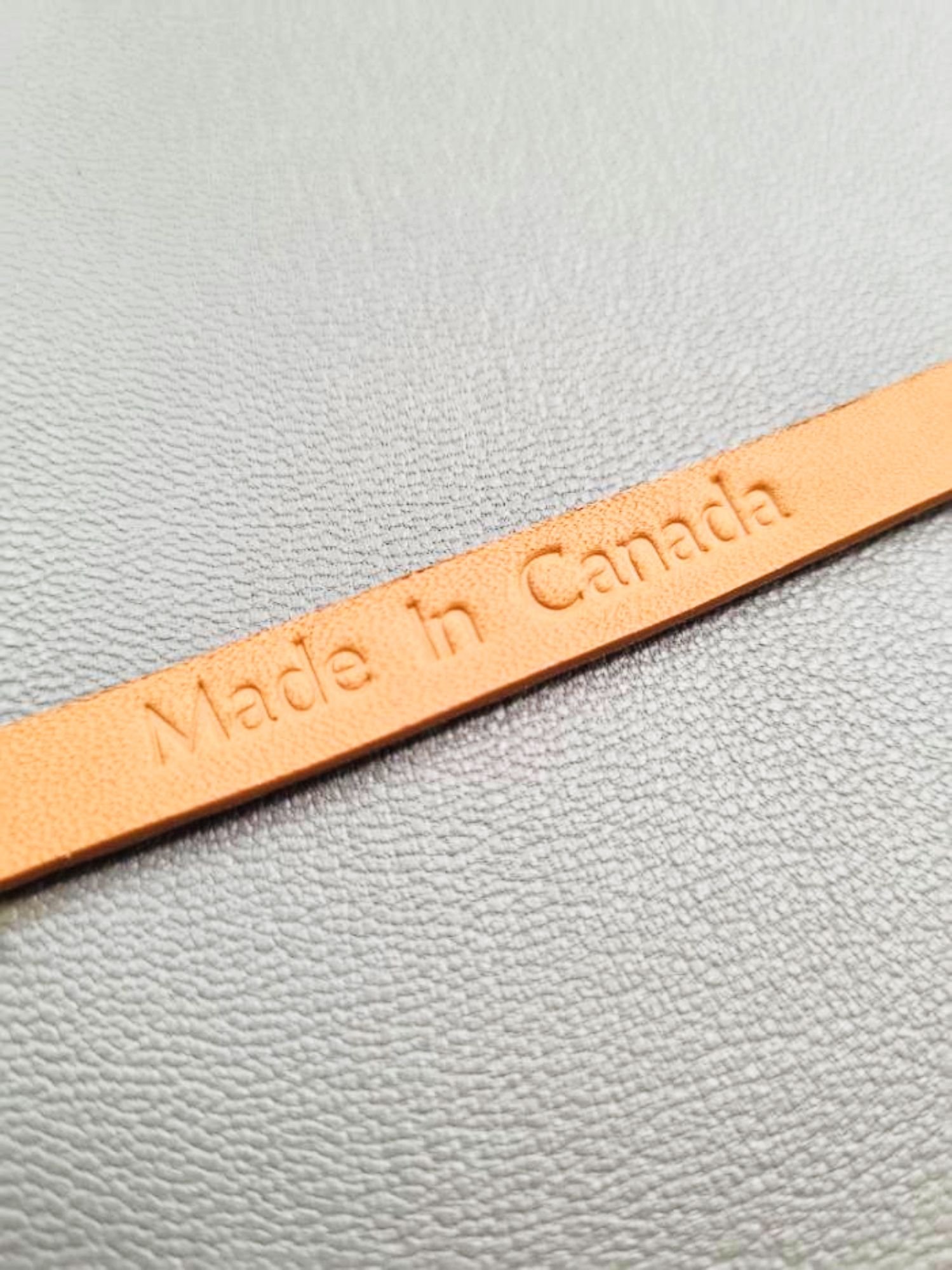 Made In Canada embossed on a luxury cognac crocodile bracelet with a magnetic clasp, made by Pila Luxuria in Canada.