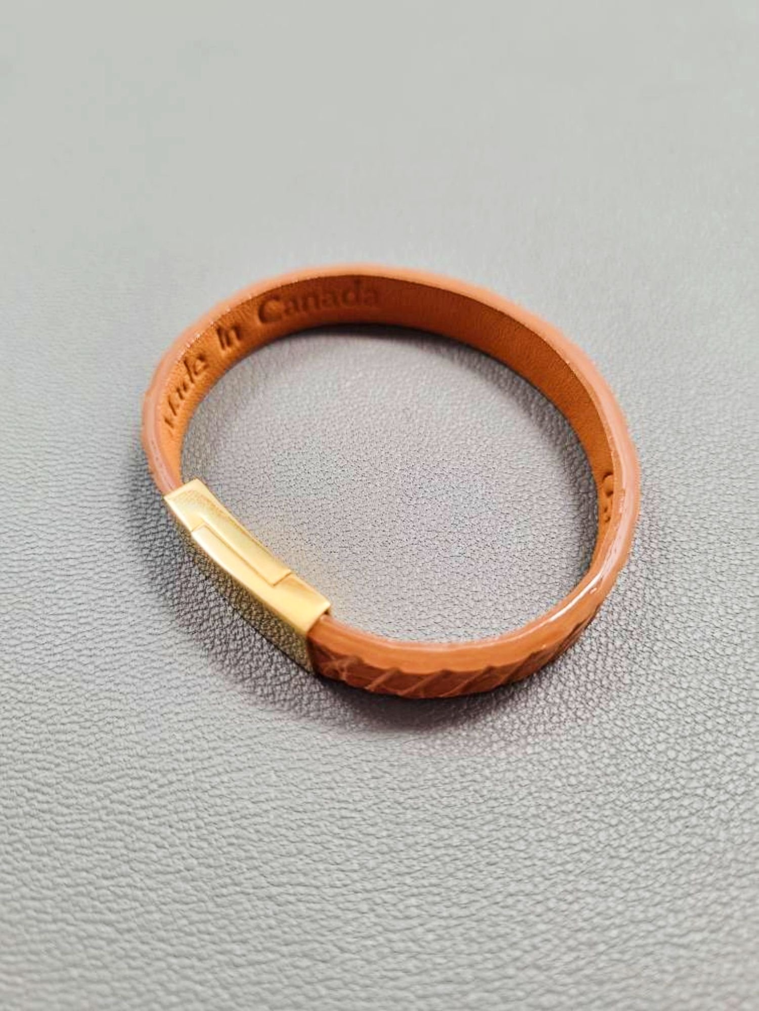 Top view of a luxury cognac crocodile bracelet with a magnetic clasp, made by Pila Luxuria in Canada.