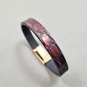 Angled view of a luxury black and red alligator leather bracelet with a magnetic clasp, made by Pila Luxuria in Canada.