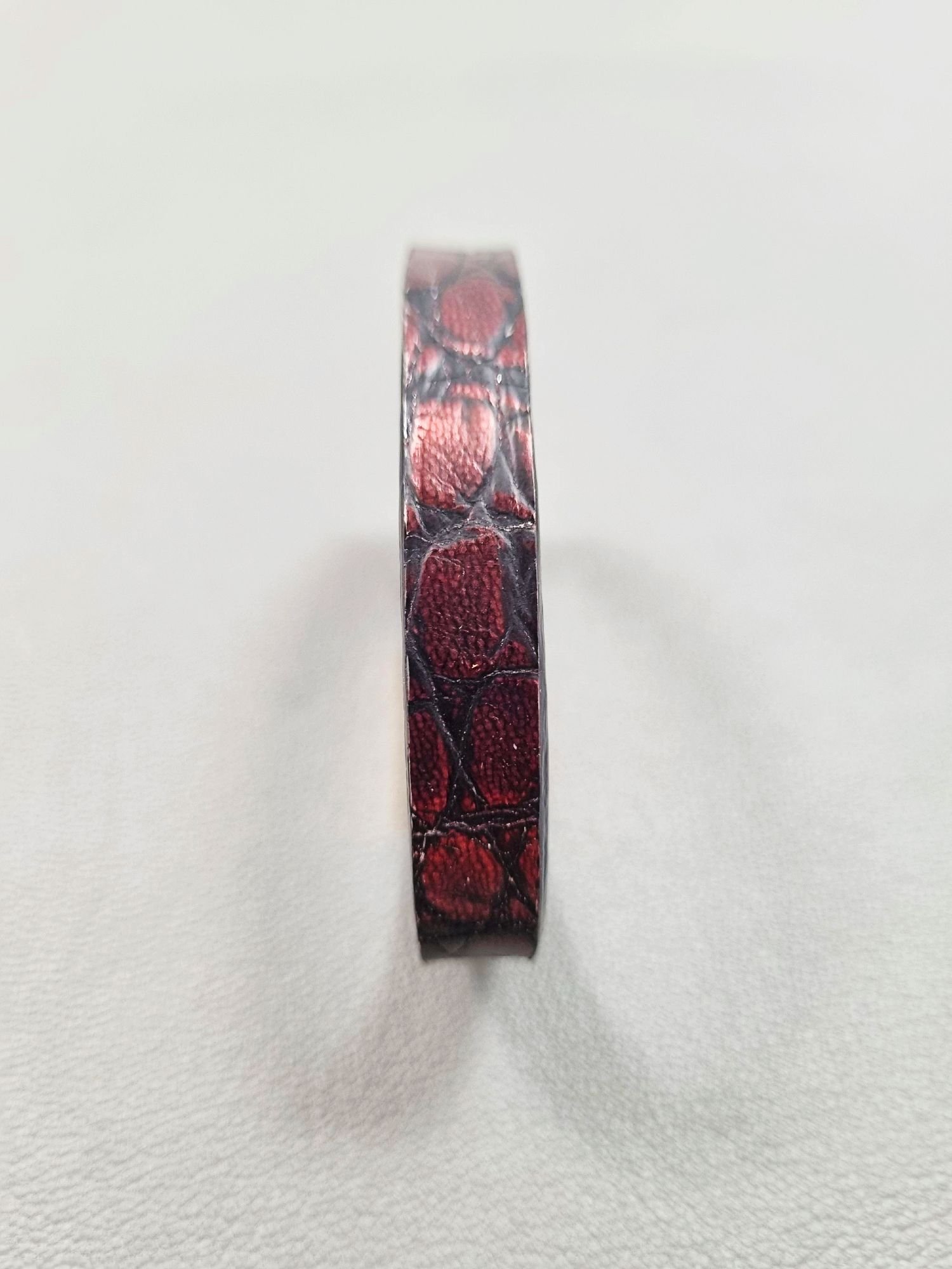 Forward view of a luxury black and red alligator leather bracelet with a magnetic clasp, made by Pila Luxuria in Canada.