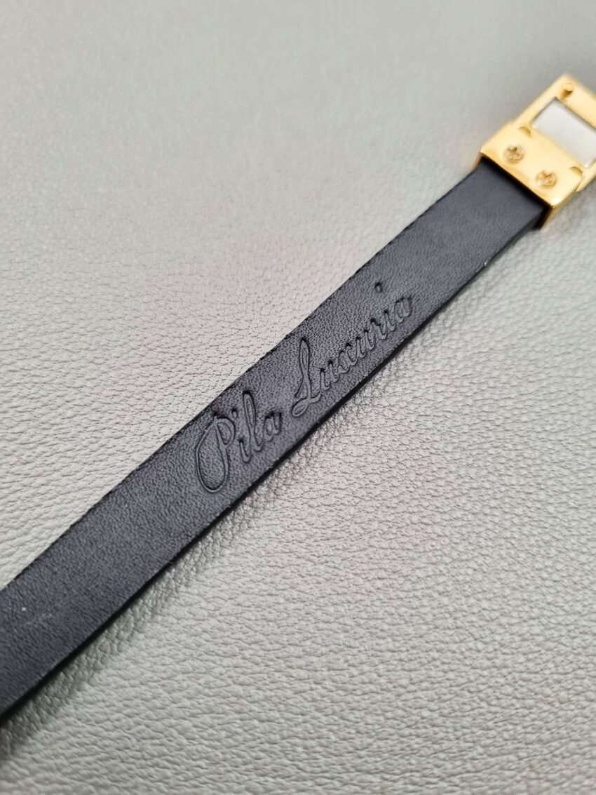 Embossed logo of a luxury black cherry alligator leather bracelet with a magnetic clasp, made by Pila Luxuria in Canada.