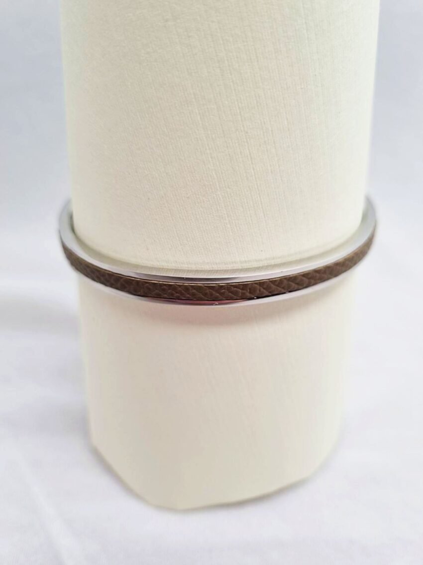 Stainless steel bracelet with etoupe epsom leather inlay.