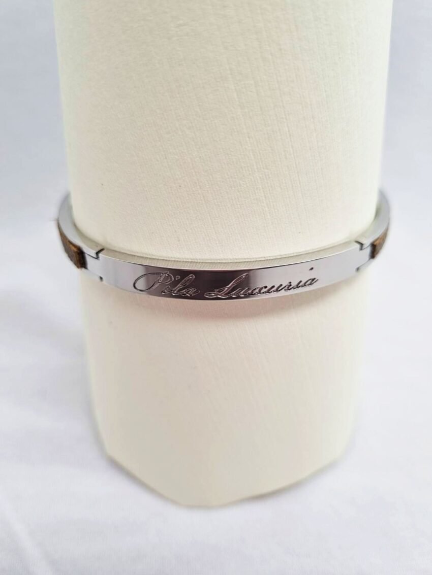 Stainless steel bracelet with etoupe epsom leather inlay and Pila Luxuria script.